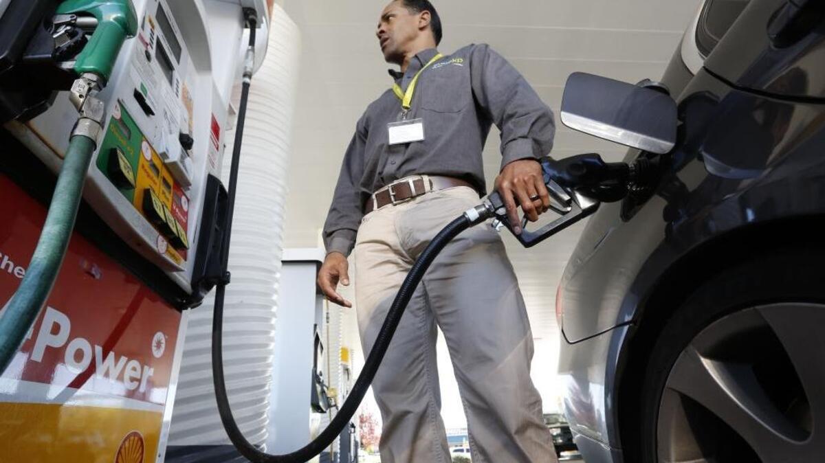Eric Henry gases up his car in Sacramento on March 7, 2014.