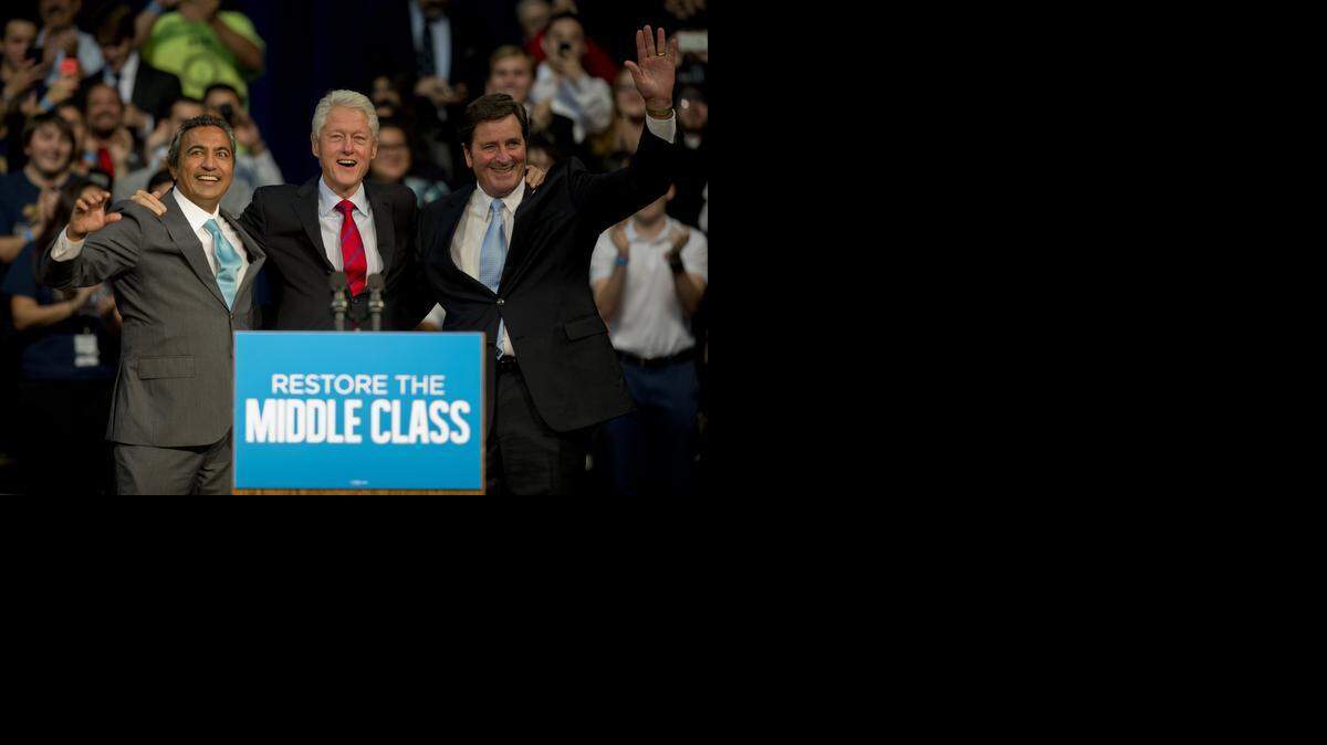
Former President Bill Clinton, center, appears at a rally at UC Davis to get out the vote for Democratic Reps. Ami Bera, left, and John Garamendi, at UC Davis on Wednesday. 
