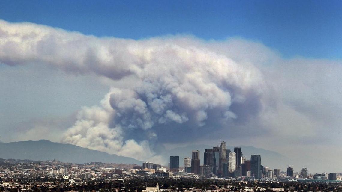 Smoke from wildfires burning in Angeles National Forest fills the sky behind the Los Angeles skyline on Monday, June 20, 2016. The National Weather Service warns that high temperatures, increased fire danger and violent oceans are predicted for Los Angeles and other parts of Southern California from July 4th through this weekend.