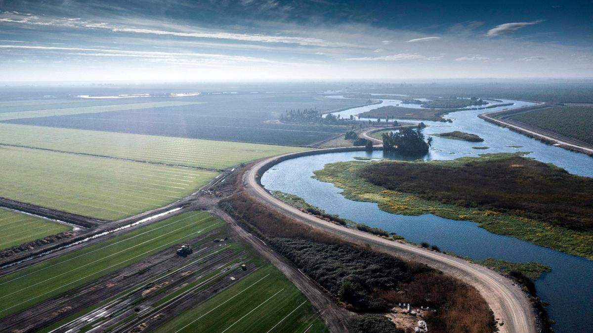 White Slough in the Sacramento-San Joaquin Delta meanders past farmland in a drone image from Tuesday, Nov. 1, 2022. The farm grows potatoes, grapes and other crops. Lobbying state lawmakers over water issues is just one reason cities and counties spend millions on private lobbying firms. 