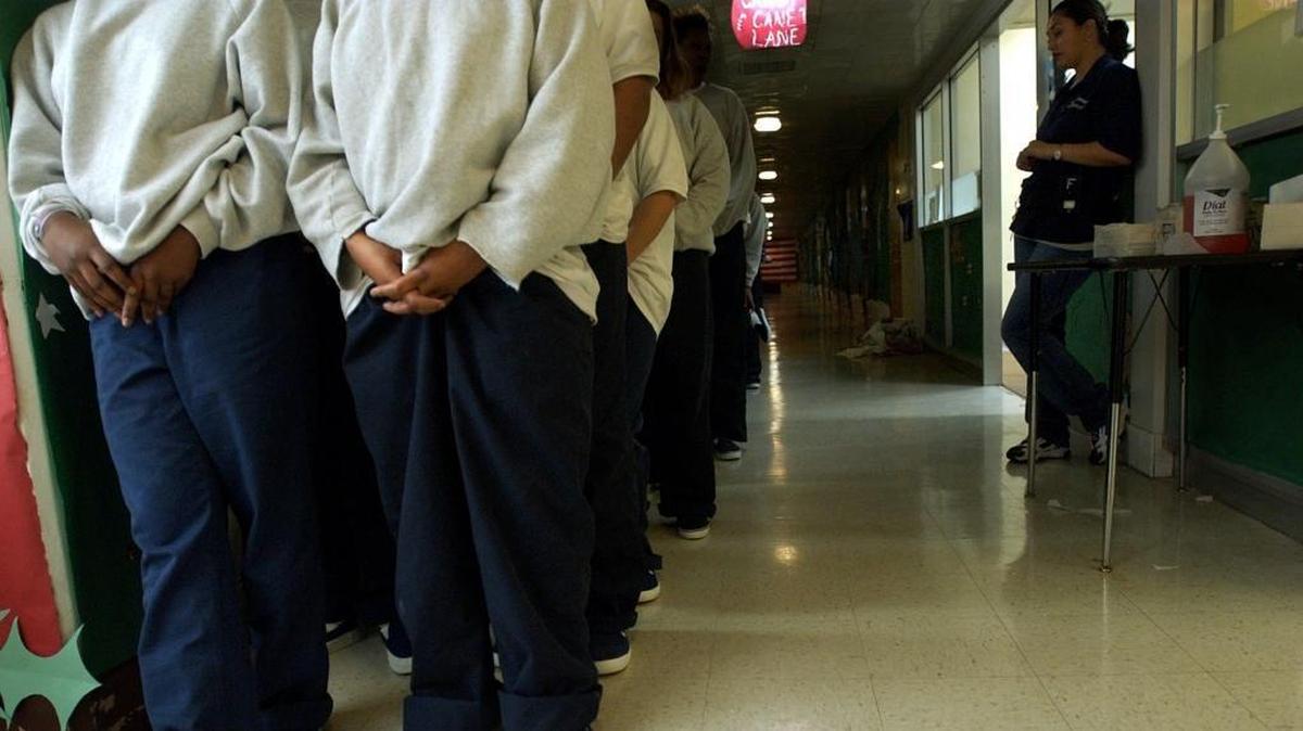 Young girls of F Unit line up to go to breakfast as they are monitored by a deputy probation officer, right, at the B.T. Collins Juvenile Center in Sacramento in 2001.