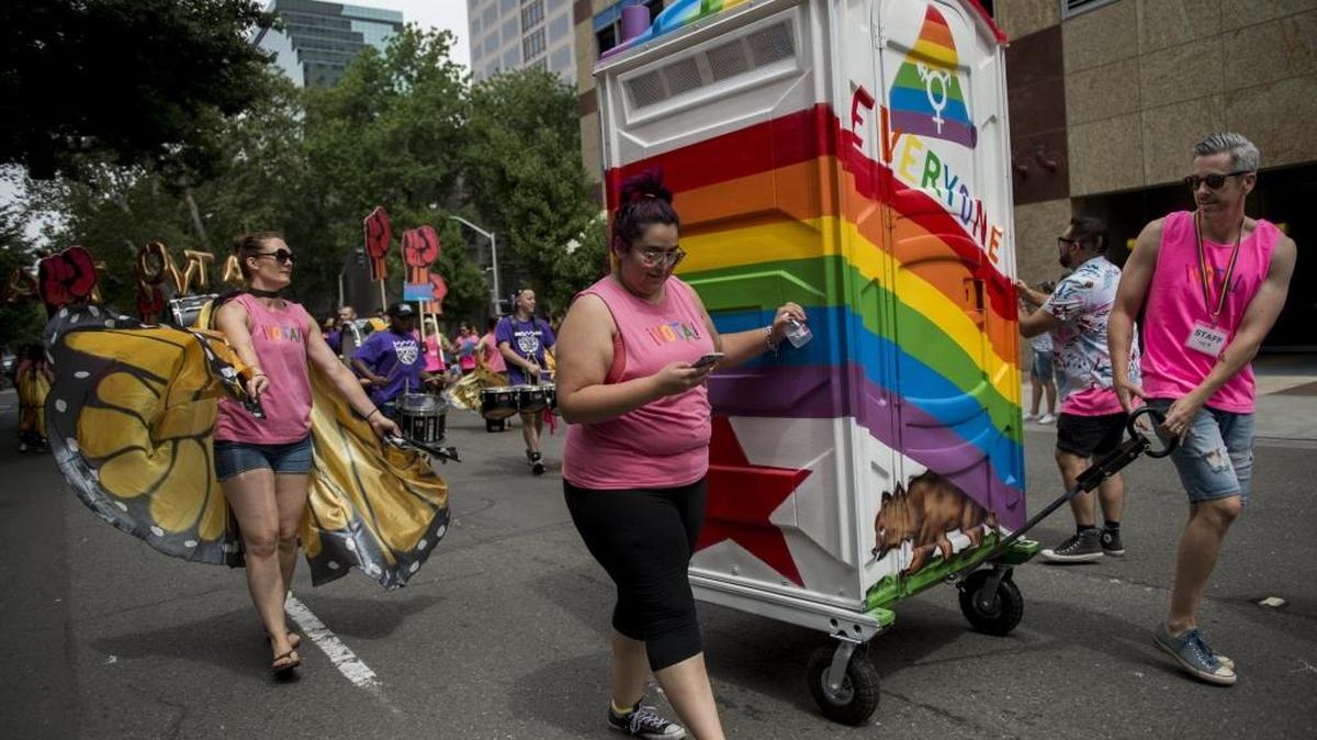 A painted and decorated portable restroom promoting transgender bathroom rights is wheeled through N street at the 32nd annual Sacramento Pride parade and festival on June 4, 2016, in Sacramento.