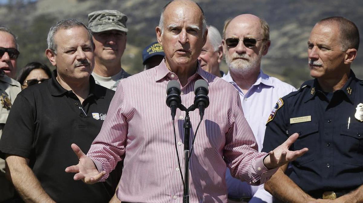 
Gov. Jerry Brown, center, speaks next to Mark Ghilarducci, director of the California Governor’s Office of Emergency Services, left, and Cal Fire Chief Ken Pimlott, right, at a news conference at Cowboy Camp Trailhead near Clearlake, Calif., Thursday, Aug. 6, 2015.
