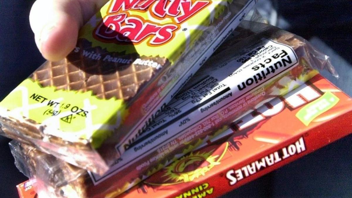 Candy products are clutched in the hand of a Folsom High School student February 7, 2003, as she comes away from the campus outdoor snack bar.