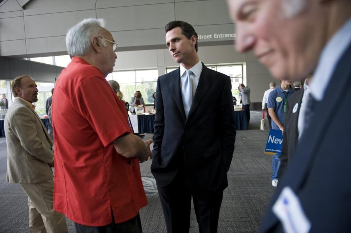 Gavin Newsom, right, then the mayor of San Francisco, speaks with John Burton, left, at the Sacramento Convention Center in 2009. 