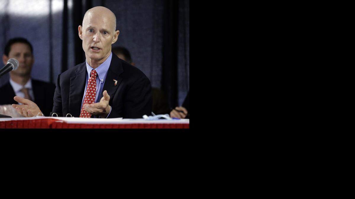 
Florida Gov. Rick Scott gestures last month during a Cabinet meeting at the Florida State Fair.
