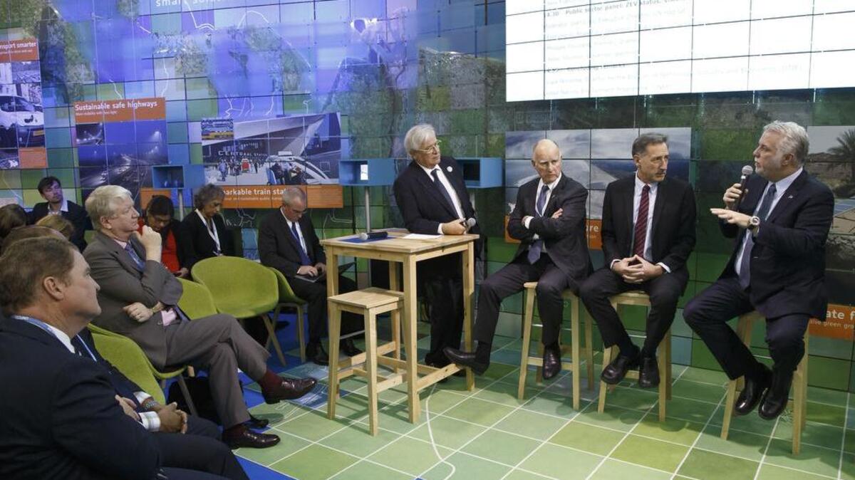 From left, U.N. Habitat Executive Director Joan Clos, Gov. Jerry Brown, Vermont Gov. Peter Shumlin and Quebec Premier Philippe Couillard attend a panel at the United Nations Climate Change Conference, in Le Bourget, France on Tuesday.