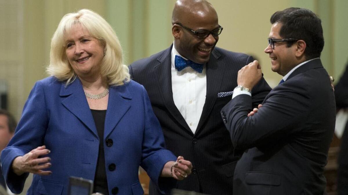 
Former Assemblywoman Connie Conway, R-Tulare, then-Assemblyman Isadore Hall, D-Compton, and Assemblyman Jimmy Gomez, D-Los Angeles, confer during a budget debate.
