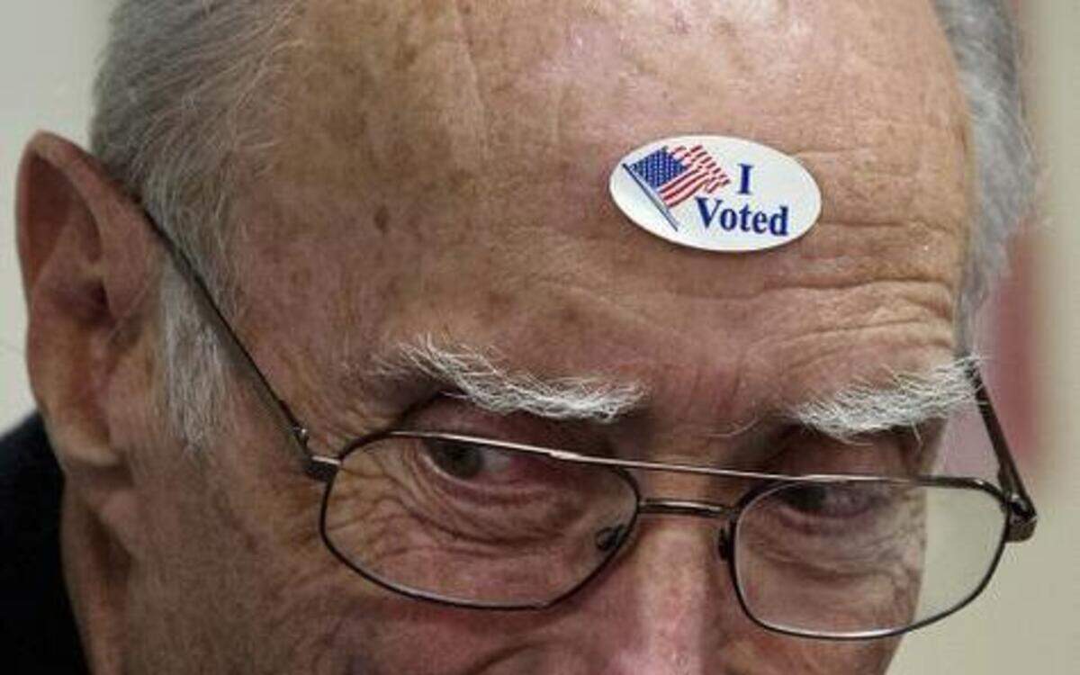 
Provisional clerk Bob Bartlett wears an "I Voted" sticker on his head at the El Dorado County Senior Center in El Dorado Hills on Nov. 6, 2012.
