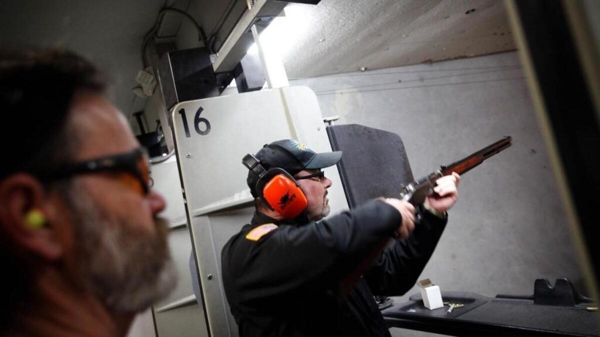 RIVERDALE, CA 020614- WATSONVILLE, CA-Staring intently, Tim Donnelly aimed a Glock 19 at a paper target bearing the picture of a zombie dressed as a British Red Coat. All but one of 15 rounds hit their mark, and the GOP gubernatorial candidate was pleased at Markley's Gunrange Feb. 6, 2014.