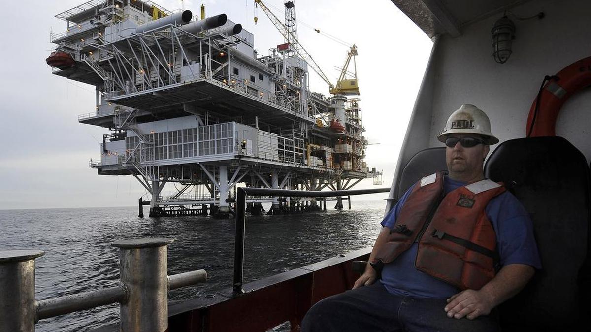In this May 1, 2009 file photo, a crew member arrives by boat at th offshore oil drilling platform "Gail", operated by Venoco, Inc., off the coast near Santa Barbara, Calif.