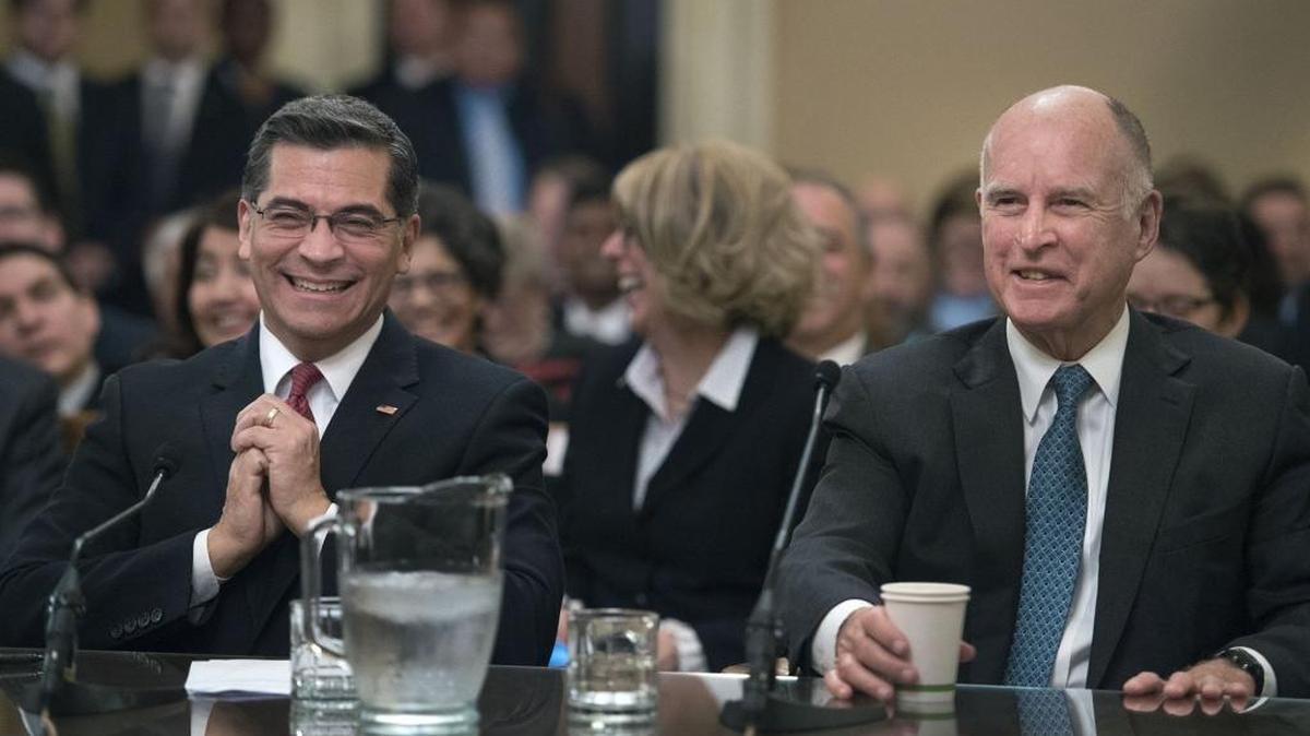 Rep. Xavier Becerra, left, and Gov. Jerry Brown share a light moment while the Assembly Committee on the Office of the Attorney General holds a hearing Tuesday on Becerra’s nomination. The full Assembly voted to confirm the nomination Friday.