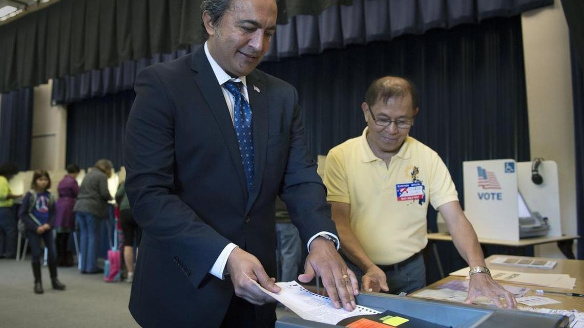 Rep. Ami Bera loads his ballot into a scanner after voting at Foulks Ranch Elementary School on Election Day on Tuesday, November 8, 2016 in Elk Grove, Calif.
