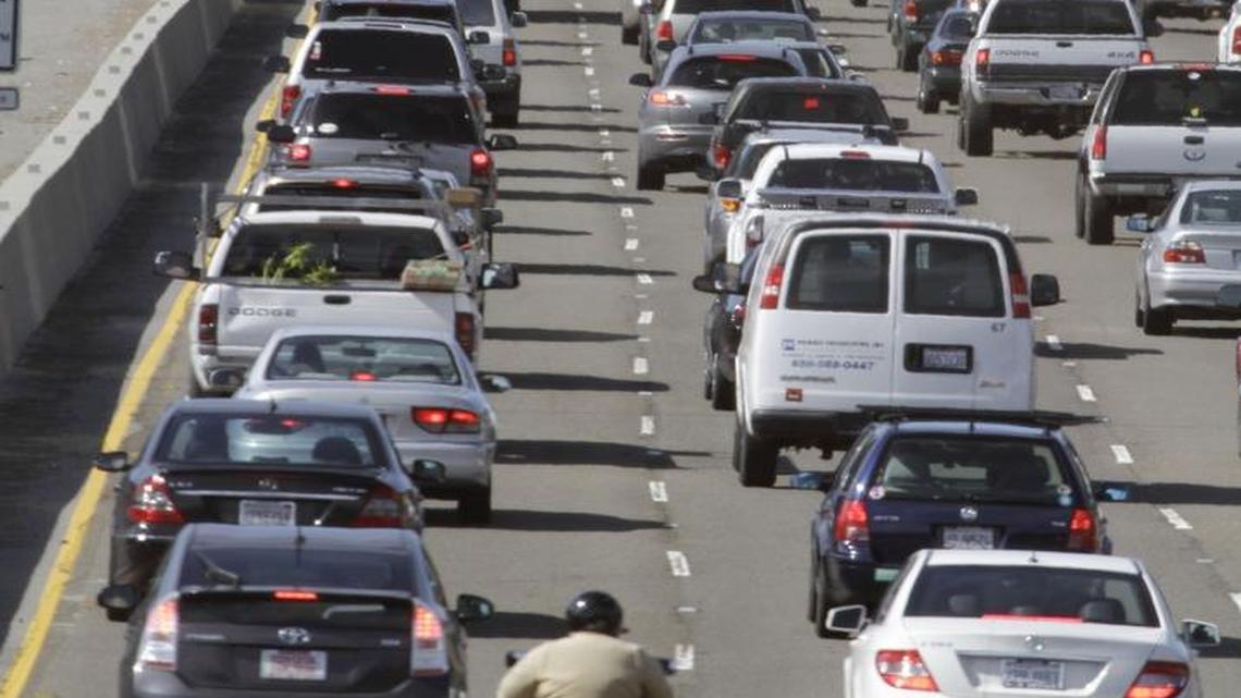 In this Thursday, May 26, 2011 file photo, a motorcyclist rides between lanes as traffic backs up on US highway 101 before the start of the Memorial Day weekend in Mill Valley, Calif.