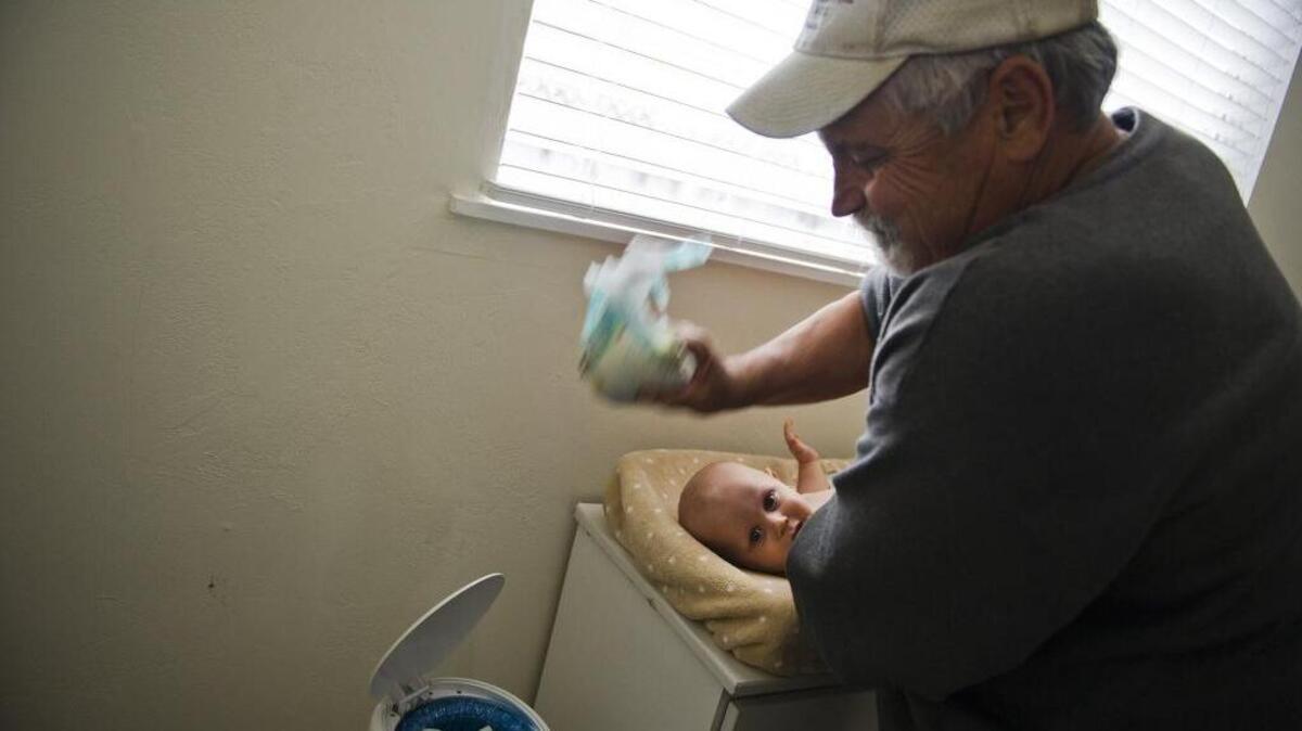 Don Hatfield changes his grandson Alex's diaper on May 3, 2012, in Napa.