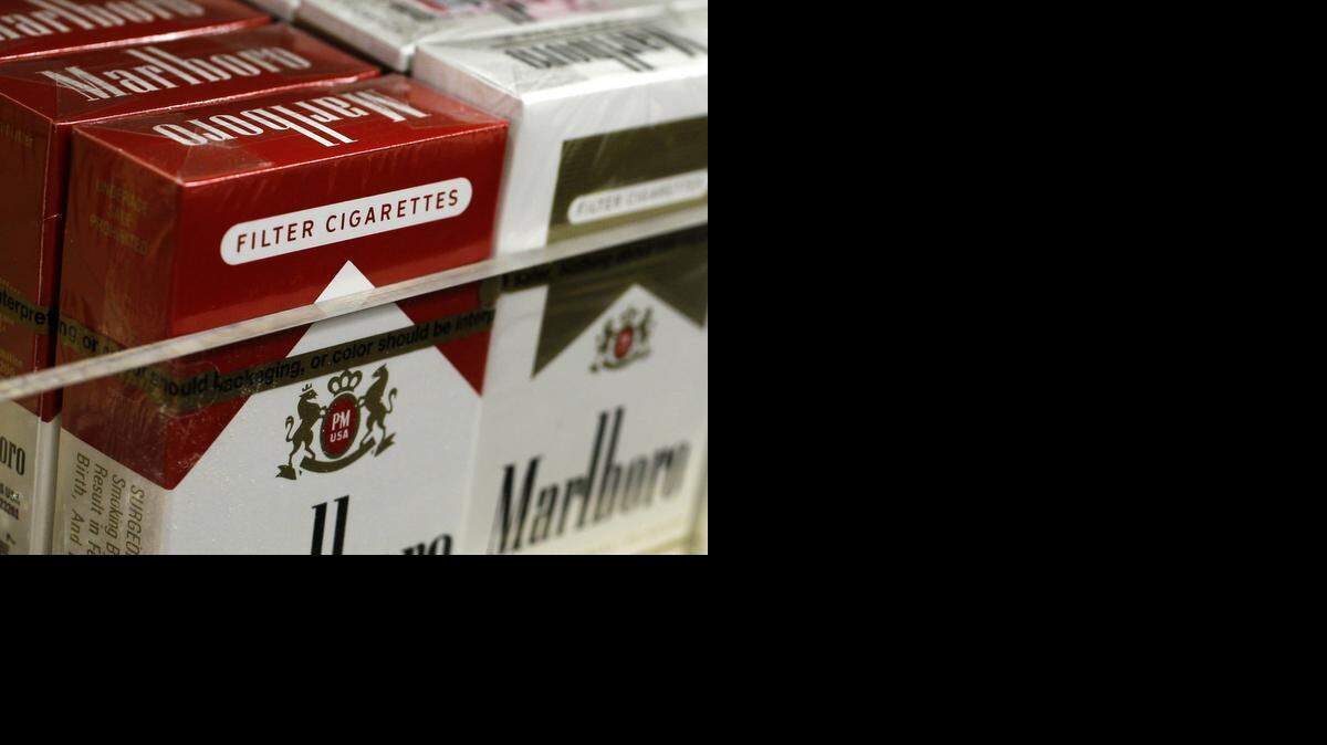 
FILE: Packs of cigarettes wait to be purchased at a Chicago news stand in 2012. A new report finds that California has one of the nation’s highest rates of cigarette smuggling.
