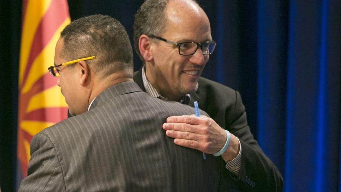 U.S. Secretary of Labor Tom Perez, right, a candidate for the Democratic National Committee chair hugs U.S. Representative Keith Ellison, D-Minnesota, also a candidate also for the DNC chair, during the DNC Future of the Party Forum at the Sheraton Grand Phoenix Hotel, Saturday, Jan. 14, 2017, in Phoenix.