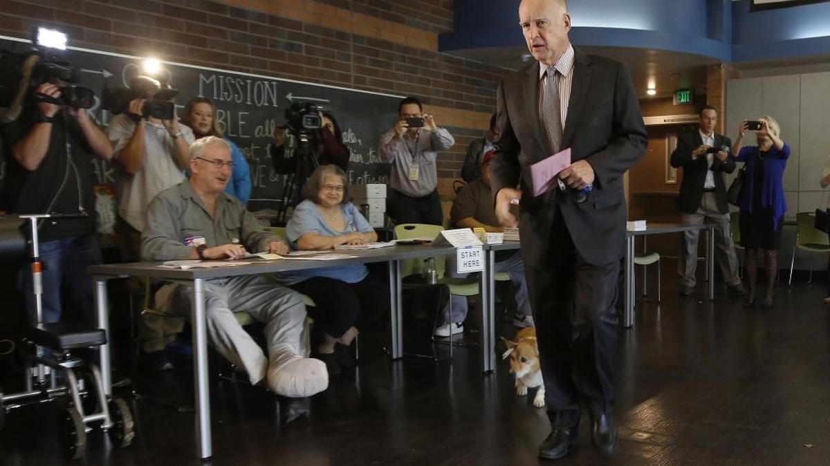 Gov. Jerry Brown walks over to deposit his mail-in ballot at his voting percent in Sacramento, Calif., Tuesday, Nov. 8, 2016. In the final weeks Brown made a last-minute push against Proposition 53, which would have required voter approval before the sale of revenue bonds of $2 billion or more.