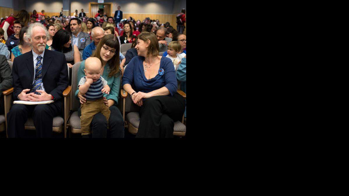 
Steven M. Rubin, PhD. of Portola Valley, left, waits to testify against Senate Bill 277, as Ariel Loop, of Pasadena who testified in favor if SB 277 holds her son Mobius who contracted measles when he was four months old. Wednesday marked the first hearing on the bill in the Senate Health Committee.
