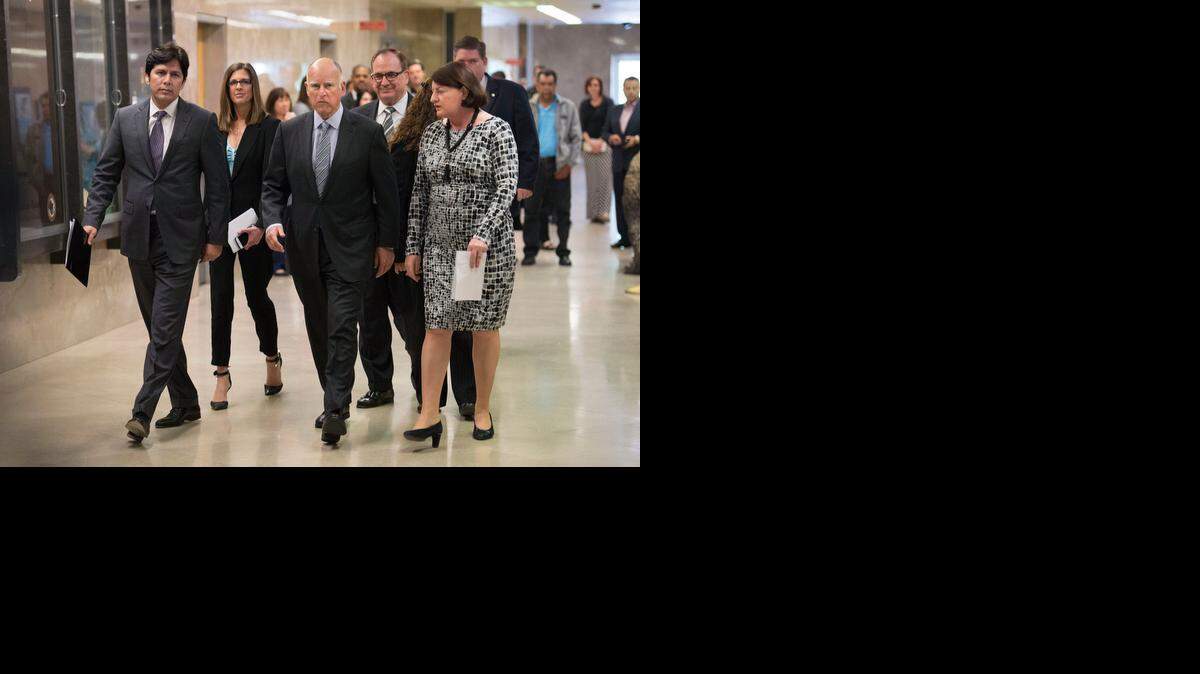 
Gov. Jerry Brown, third from left, is joined by, from left, Senate President Pro Tem Kevin de León, Assembly Republican Leader Kristin Olsen, Senate Republican Leader Bob Huff and Assembly Speaker Toni Atkins, as they head to a Capitol news conference where they announced a $1.1 billion emergency drought package on Thursday.
