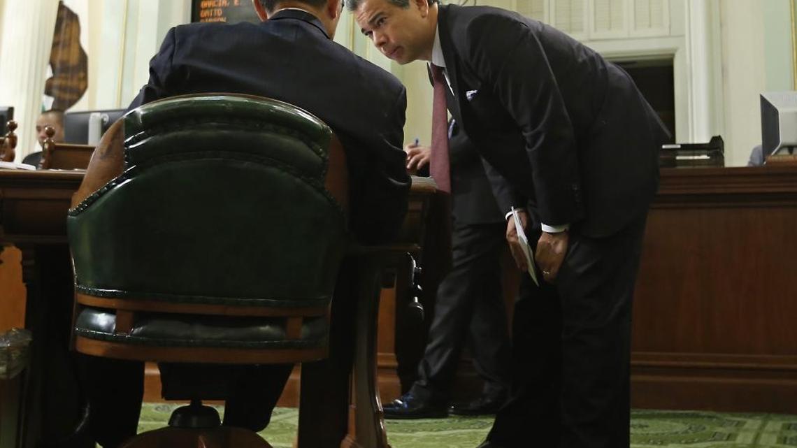 
Democratic Assembly members Kansen Chu, of San Jose, left, and Rob Bonta, of Alameda, confer, during the Assembly session, Thursday, Sept. 10, 2015, in Sacramento, Calif. Lawmakers had nearly 2,000 opportunities to vote in 2015.
