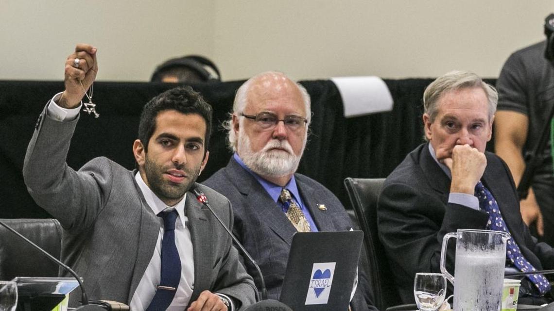 University of California’s student regent, Avi Oved, left, holds up a Star of David as he discusses a controversial policy statement on intolerance on Sept. 17, 2015.