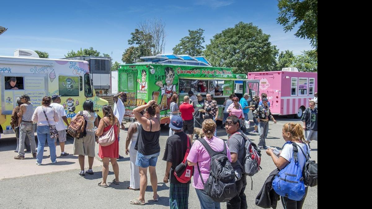 
Three of the eleven food trucks with SactoMoFo serve their products to Loaves & Fishes homeless community in June. A new study by United Ways of California concludes that nearly a third of California’s households “struggle each month to meet basic needs,” largely because of the state’s high cost of living.
