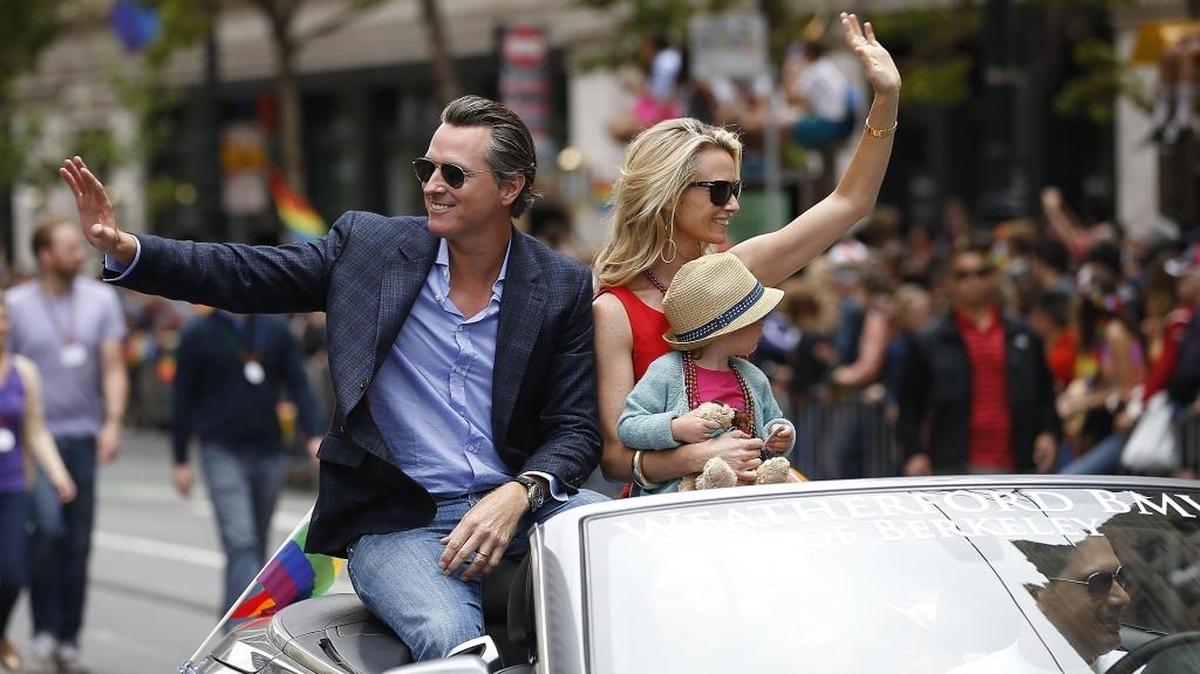 California Lt. Gov. Gavin Newsom, left, and his wife Jennifer holding daughter Brooklynn, wave to spectators during the 45th annual San Francisco Gay Pride parade Sunday, June 28, 2015, in San Francisco.
