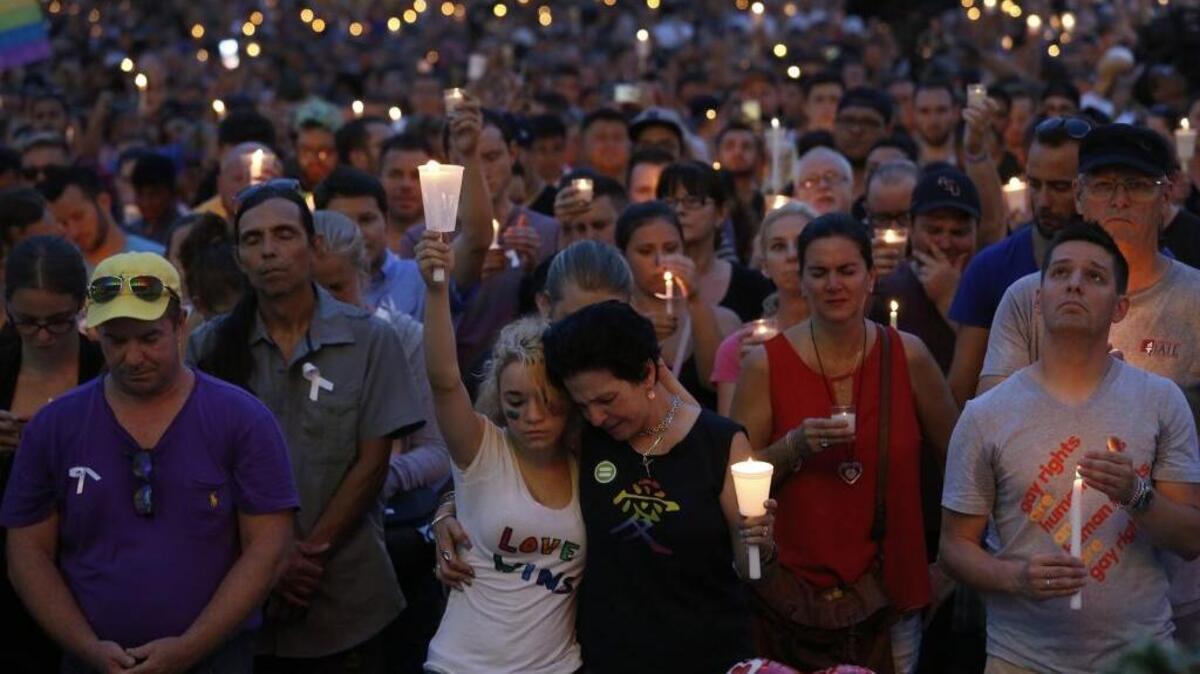 Madeline Lago, 15, and her mother, Carmen Lago, center, joined thousands for a memorial rally at the Dr. Phillips Performing Arts Center in Orlando on June 13, 2016, to honor those killed and wounded in the Pulse nightclub attack.