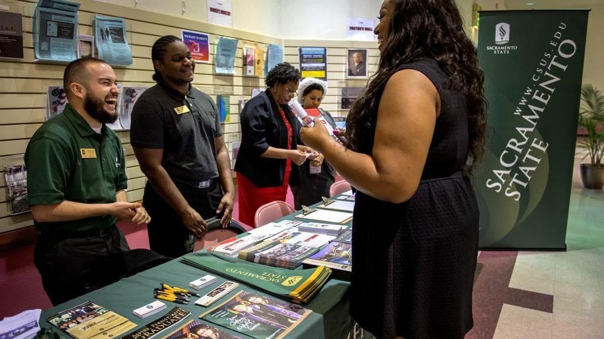 Donaciano Botello, 26, left, a first year Master's student at Sacramento State University, works as a volunteer at a Sacramento State Super Sunday event in 2015 to help recruit Quanisha Sims, 26, right, who recently moved to Sacramento.
