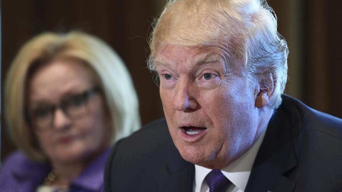 President Donald Trump, right, sitting next to Sen. Claire McCaskill, D-Mo., left, speaks during a meeting with members of the Senate Finance Committee and members of the President's economic team in the Cabinet Room of the White House in Washington, Wednesday, Oct. 18, 2017.