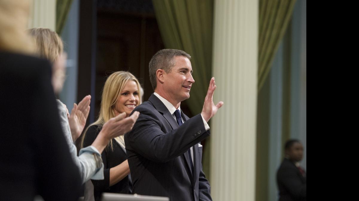 
Assemblyman Jeff Gorell, R-Camarillo, with his wife Laura, acknowledges the standing ovation form California Assembly members at the California State Capitol on Monday, April 9, 2012, as he returned after a year of service as a Lt. Commander in Afghanistan with the U.S. Navy.

