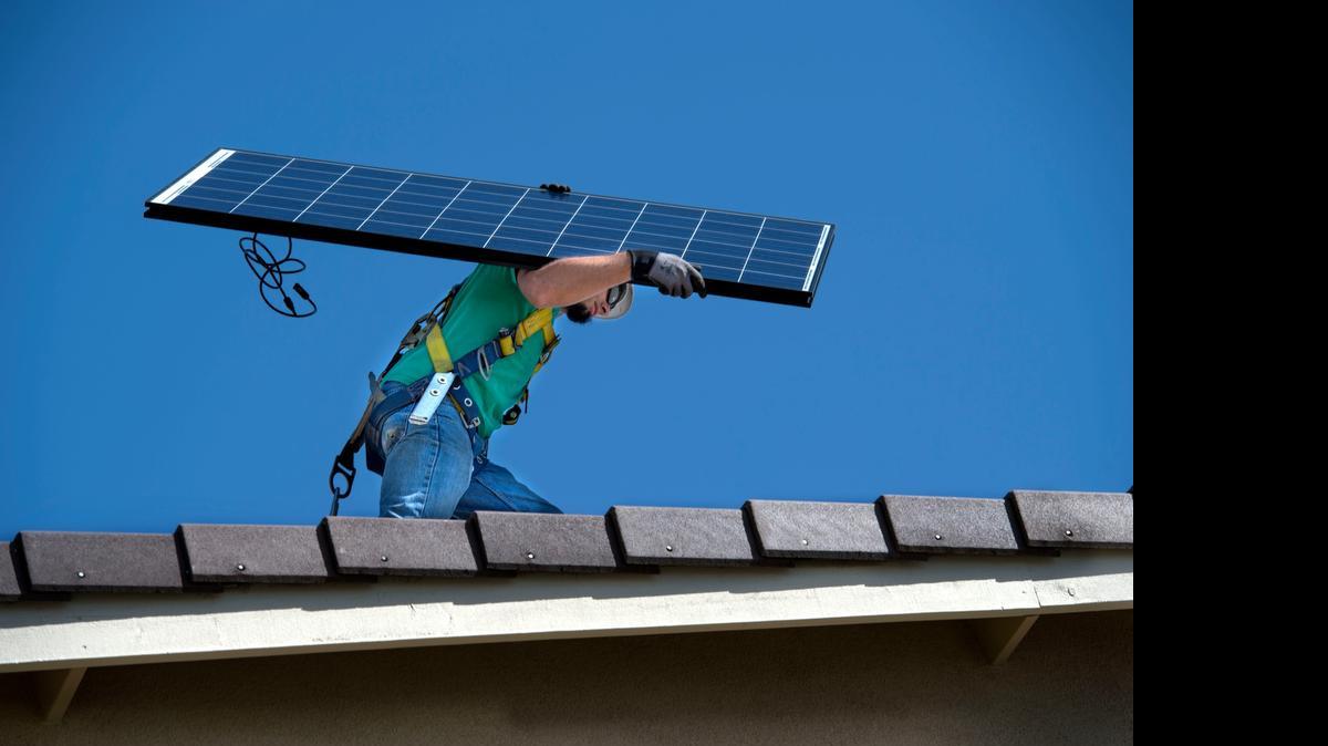 
Nate Lehrer of Carmichael, a senior installer with SolarCity, carries a solar panel to be installed on a job in West Sacramento on Friday, April 10, 2015. Capitol policymakers are advancing an ambitious proposal to have renewable sources generate half of the state’s electricity by 2030, up from the 33 percent benchmark already in law.

