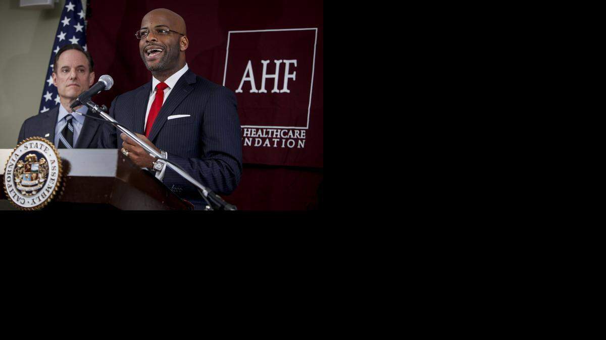 
Then-Assemblyman Isadore Hall speaks as Michael Weinstein, president of the AIDS Healthcare Foundation, looks on at a 2013 news conference to support laws requiring porn actors to use condoms.
