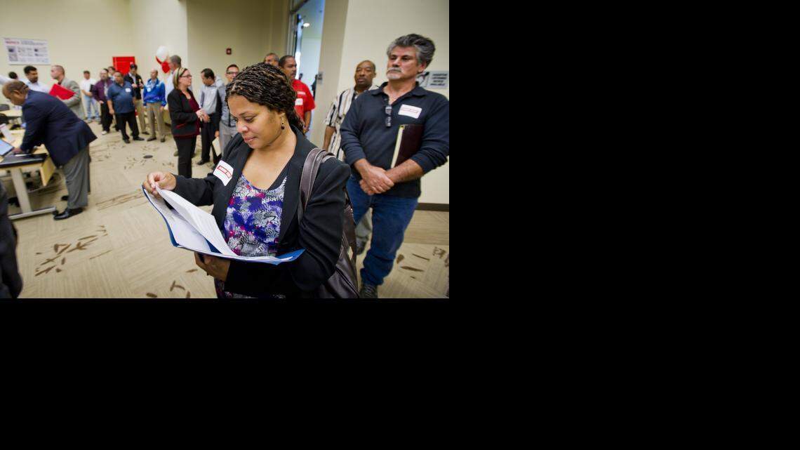 
Angela Brady of Sacramento checks her resume while she waits in line for an interview during a job fair at Mori Seiki USA, which was planning to open a factory in Davis in 2012. October 4, 2011

