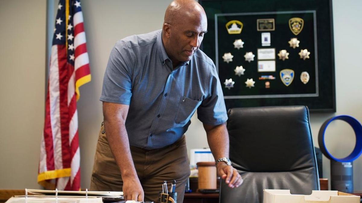 
A frame behind Assemblyman Jim Cooper’s Capitol office desk displays badges he accumulated through his years in law enforcement. Cooper is one of two ex-cops in the Legislature.
