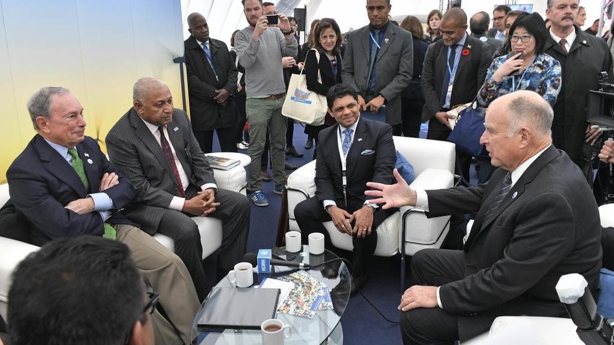 Former New York Mayor Michael Bloomberg, left, speaks with Fiji prime minister and COP president Frank Bainimarama, beside him, and California Gov. Jerry Brown, right, in the U.S. Climate Action Center at the COP 23 Fiji UN Climate Change Conference on Saturday in Bonn, Germany.