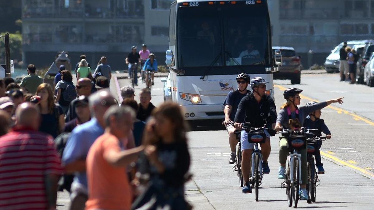 Bicyclists make their way down Bridgeway in September 2014 in Sausalito. Combined with visitors who show up in buses, ferries and cars, the annual tourist crunch has spurred ongoing public debate, a program that stations bike valets and ambassadors on the streets and a controversial, yet unsuccessful, push to put a tourist impact plan on the June ballot.