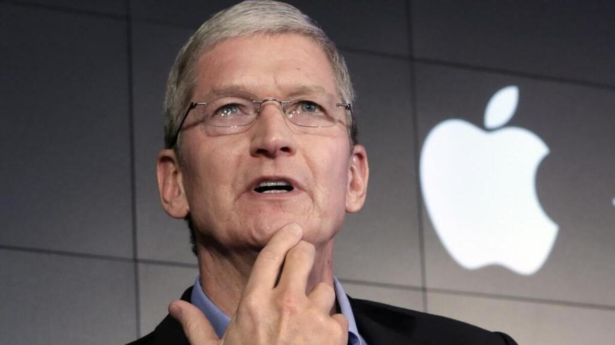 Apple CEO Tim Cook responds to a question during a news conference at IBM Watson headquarters in New York on April 30, 2015.