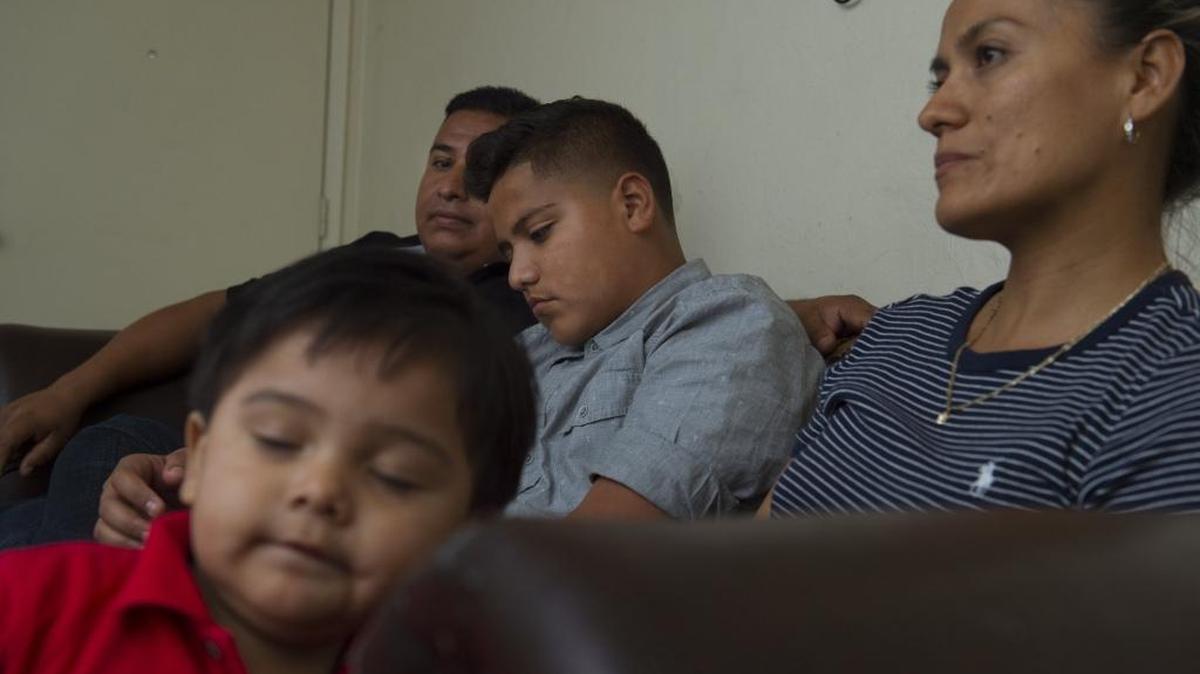 Felix Gonzalez, 13, is shown with his parents Victor and Gabriela Gonzalez, and younger brother Victor,1 in their apartment in Woodland last April. He previously lacked medical insurance coverage but was scheduled to receive coverage a month later under an expansion of Medi-Cal, the state’s health care system for the poor.