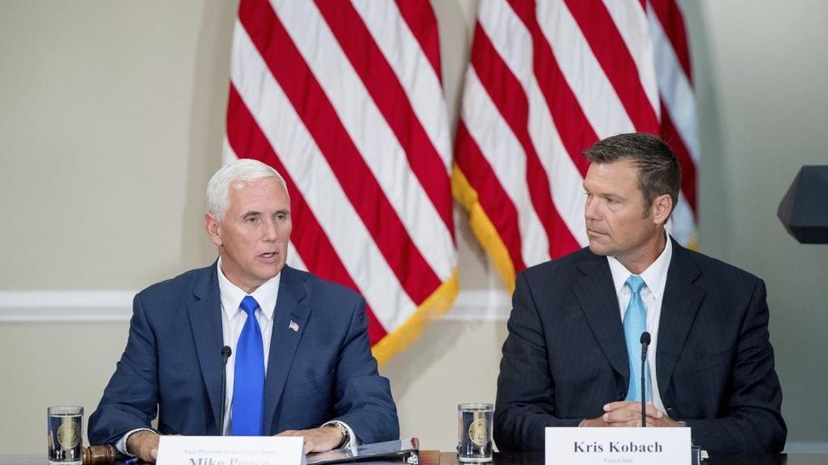 Vice President Mike Pence, left, accompanied by Kansas Secretary of State Kris Kobach, speaks during the first meeting of the Presidential Advisory Commission on Election Integrity at the Eisenhower Executive Office Building on the White House complex in Washington on July 19, 2017. A conservative legal group has threatened to sue California Secretary of State Alex Padilla over the issue of inactive voters.