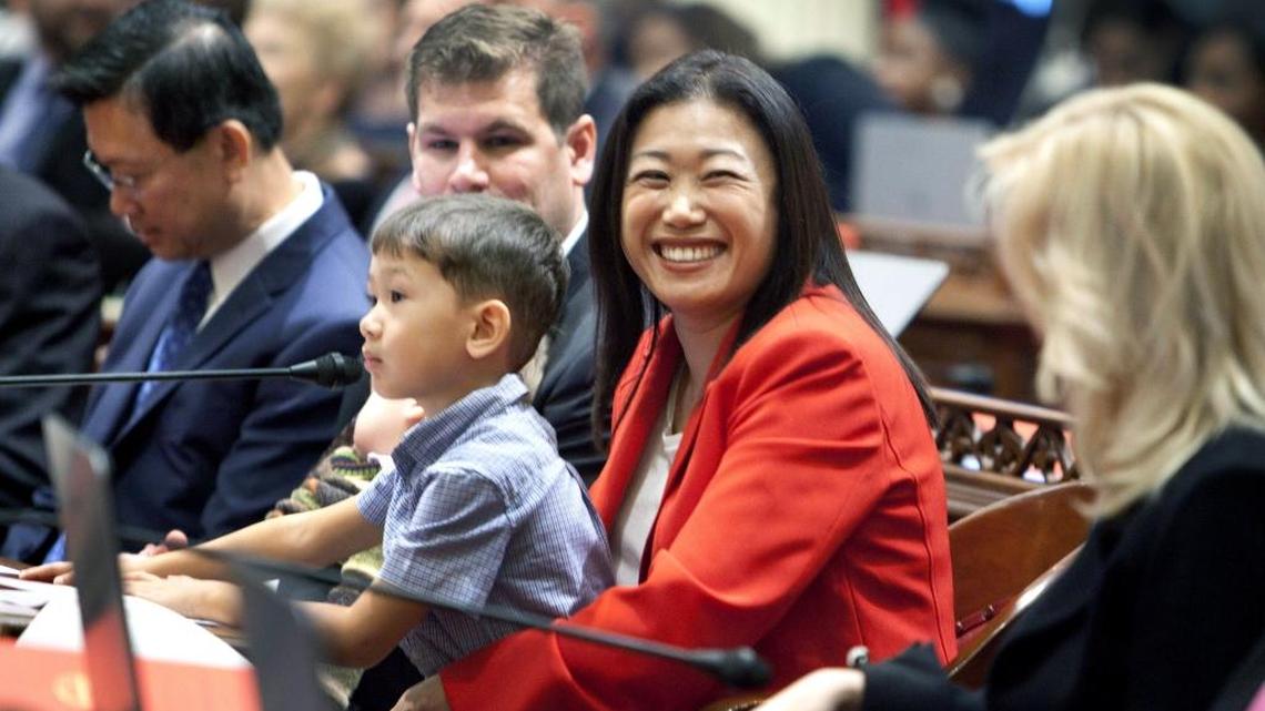 New Sen. Janet Nguyen, R-Santa Ana, holds her son before a swearing-in ceremony on the floor of the Senate Chambers on Dec. 1, 2014.