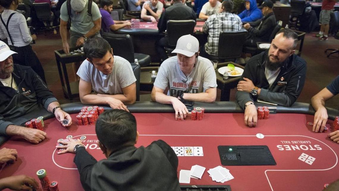David Le, from left, Chris Penfield and Jake Rosenstiel wait to place bets during a game of Texas Hold’em Poker at the Stones Gambling Hall in Citrus Heights, California on July 14, 2016. Texas Hold’em is not subject to a new rule dictating rotation of the dealer. Games like Pai Gow and Blackjack would be subject to the new rule.