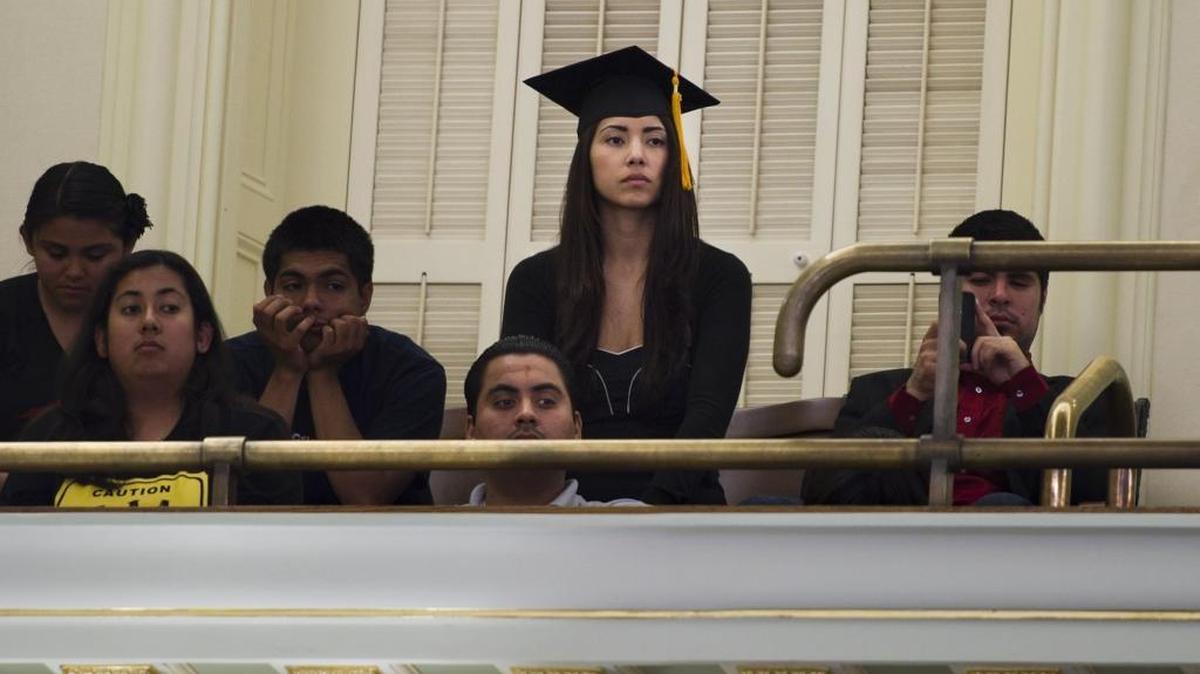 Maria Luna, 23, of Sacramento, who is undocumented wears her graduation cap from California State University Sacramento.