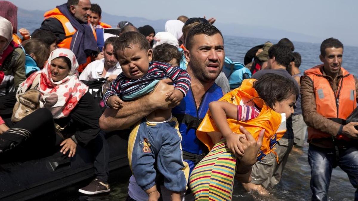 Syrian refugees arrive aboard a dinghy after crossing from Turkey to the island of Lesbos, Greece, Thursday, Sept. 10, 2015.