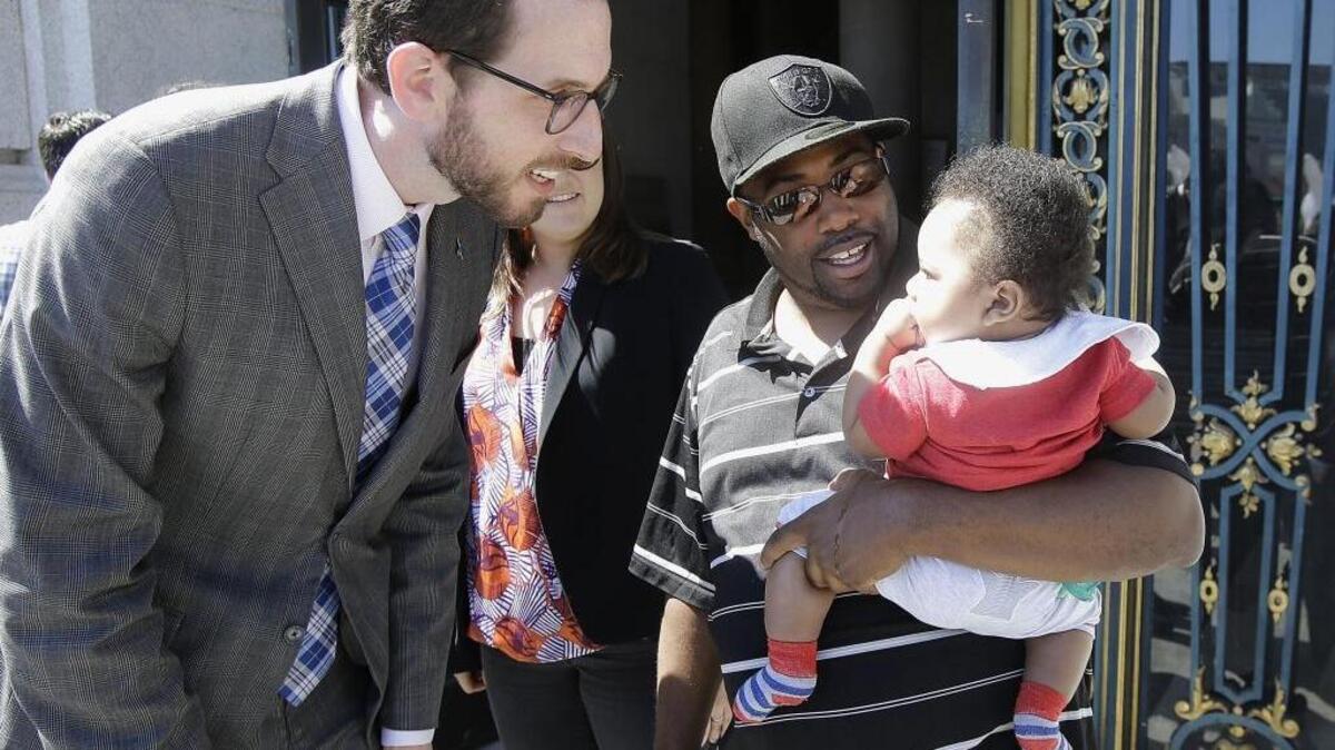 San Francisco Supervisor Scott Wiener, left, speaks to a child before a rally supporting paid family leave at City Hall in San Francisco last month. Outside groups had spent $219,000 through Wednesday, May 25, 2016, to help elect Wiener to the state Senate.