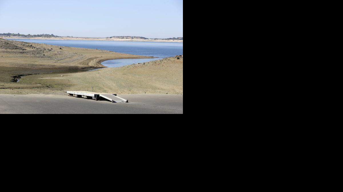 
In this Oct. 6, 2014 file photo, a dock sits high and dry at the end of a boat ramp yards away from the edge of Folsom Lake near Folsom, Calif. 
