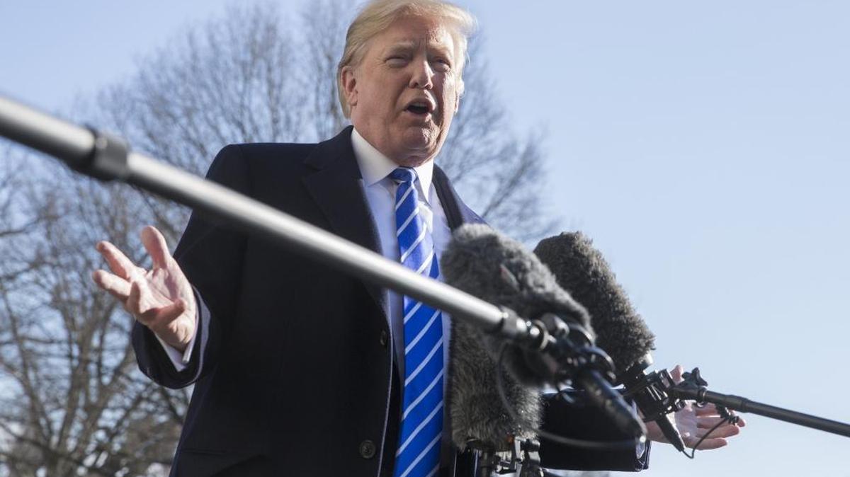 President Donald Trump speaks with the media before departing for Camp David on the South Lawn of the White House in Washington on Dec. 16, 2017.