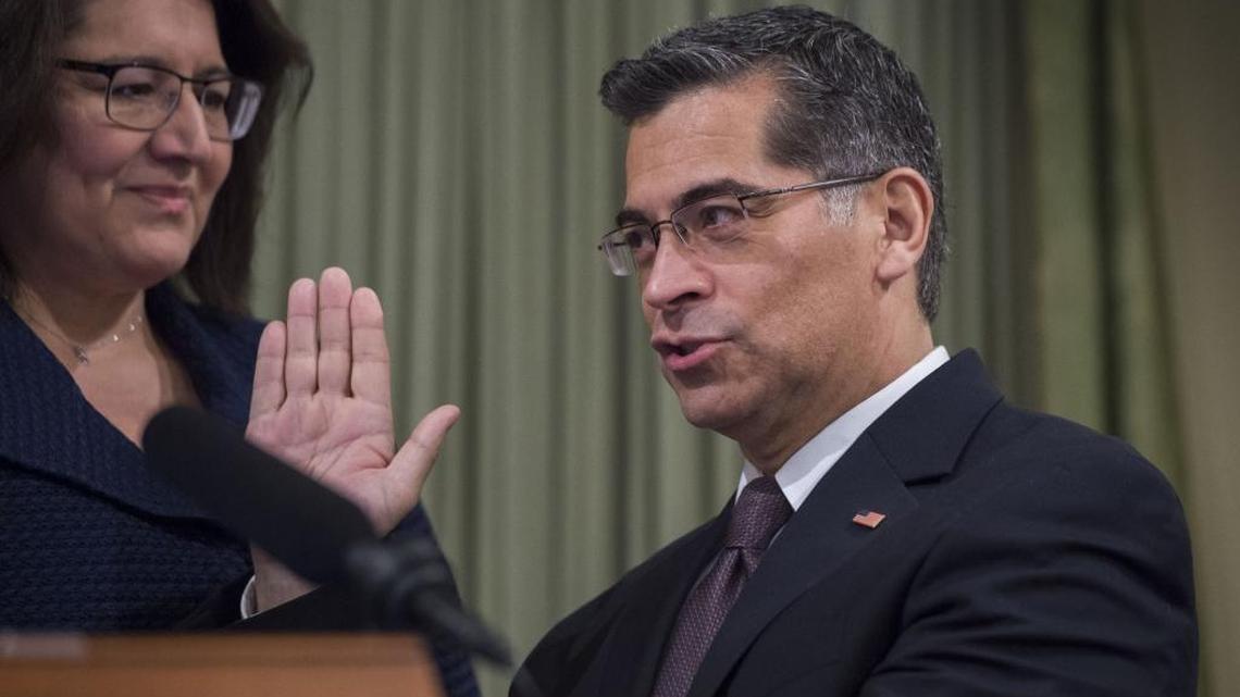 Democrat Xavier Becerra is sworn in as California's first Latino attorney general with his wife, Dr. Carolina Reyes, in Sacramento on Tuesday.