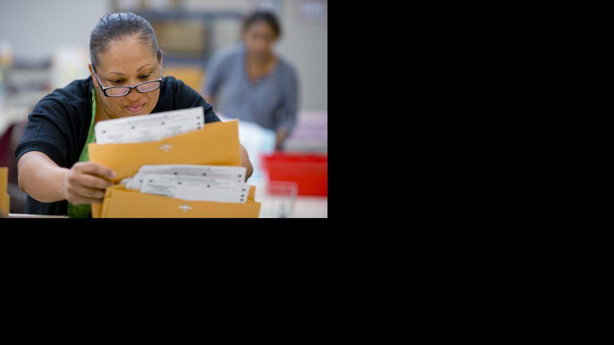 
Alexandra Peace sorts voters’ paperwork at the registrar's office in South Sacramento on June 2, 2014.
